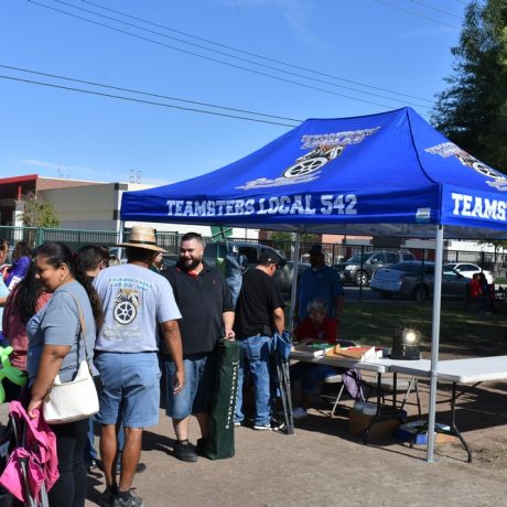 People standing by Teamsters Local 542 Tent
